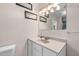 Bright bathroom with a light-colored vanity, mirror, and decorative wall art at 110 Starlite Dr, Carrboro, NC 27510