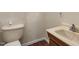 Small bathroom featuring a toilet and a light brown marble sink at 110 Starlite Dr, Carrboro, NC 27510