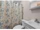 Cozy bathroom featuring a patterned shower curtain, white vanity, and toilet at 110 Starlite Dr, Carrboro, NC 27510