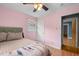 Another angle of the pink bedroom showing a bed, window and entry to another room at 110 Starlite Dr, Carrboro, NC 27510