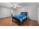 Bright bedroom featuring hardwood floors, ceiling fan, and a comfortable bed with blue bedding at 110 Starlite Dr, Carrboro, NC 27510