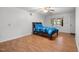 Bedroom with hardwood floors, ceiling fan, and a comfortable bed with blue bedding at 110 Starlite Dr, Carrboro, NC 27510