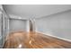 Spacious empty room with gleaming hardwood floors and neutral walls at 110 Starlite Dr, Carrboro, NC 27510