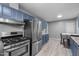 Well-equipped kitchen with modern appliances, blue cabinetry, and ample counter space at 110 Starlite Dr, Carrboro, NC 27510