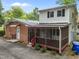 View of the home's rear exterior showing the screened-in porch and brickwork at 110 Starlite Dr, Carrboro, NC 27510