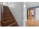 Stairway featuring wooden steps and access to an open doorway at 110 Starlite Dr, Carrboro, NC 27510