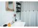 Bathroom features a sink and a shower with a curtain and a window for natural light at 1146 W Holt St, Mebane, NC 27302