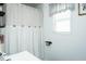 Bathroom features a shower with a curtain and a window for natural light at 1146 W Holt St, Mebane, NC 27302