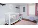 Bright Bedroom with crib, rug, and chair at 1146 W Holt St, Mebane, NC 27302