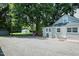 Charming home exterior with an ample sized parking area and a storage shed at 1146 W Holt St, Mebane, NC 27302