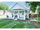 Charming bungalow with gray painted brick, covered porch, and American flag at 1146 W Holt St, Mebane, NC 27302