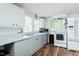 Bright kitchen features wood floors, white cabinets, and modern appliances at 1146 W Holt St, Mebane, NC 27302
