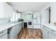 Bright kitchen features wood floors, white cabinets, and modern appliances at 1146 W Holt St, Mebane, NC 27302