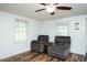 Inviting living room with ceiling fan, wood laminate floors, and natural light at 1146 W Holt St, Mebane, NC 27302