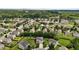 Aerial view of a residential neighborhood with tree-lined streets and well-maintained homes at 119 Tadworth Ct, Mebane, NC 27302