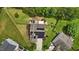 Aerial view of a home with solar panels, a patio set, and mature landscaping in a well-maintained backyard at 119 Tadworth Ct, Mebane, NC 27302