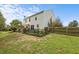 Large backyard with a fenced garden, pergola, and plenty of space for outdoor activities at 119 Tadworth Ct, Mebane, NC 27302