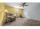 Bright and airy bedroom with yellow and light blue walls, features comfortable seating and natural light from the window at 119 Tadworth Ct, Mebane, NC 27302