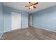 Blue bedroom featuring closet space and a doorway with a television at 119 Tadworth Ct, Mebane, NC 27302