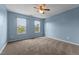 Sunny bedroom with ample natural light from two windows and neutral carpet at 119 Tadworth Ct, Mebane, NC 27302