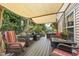 Inviting outdoor deck with comfortable seating, a sunshade, and charming decor at 119 Tadworth Ct, Mebane, NC 27302