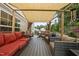 Spacious covered deck with comfortable seating and a view of the backyard at 119 Tadworth Ct, Mebane, NC 27302