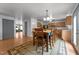 An open dining area features a wooden table and chairs next to an open kitchen area with light wood cabinets at 119 Tadworth Ct, Mebane, NC 27302