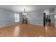 Formal dining room with hardwood floors, chandelier, view of the adjoining kitchen, and ample natural light at 119 Tadworth Ct, Mebane, NC 27302