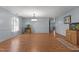Light-filled dining room with hardwood floors, chandelier, and neutral color scheme, with decorative fish tanks at 119 Tadworth Ct, Mebane, NC 27302