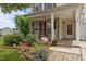 Inviting front porch with stone accents, rocking chairs, and charming landscaping at 119 Tadworth Ct, Mebane, NC 27302