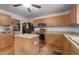 Functional kitchen featuring stainless steel appliances, wood cabinets, a center island, and convenient laundry area at 119 Tadworth Ct, Mebane, NC 27302