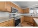 A well-lit kitchen features stainless steel appliances, light wood cabinets, and durable countertops for meal preparation at 119 Tadworth Ct, Mebane, NC 27302
