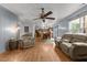 Open living area with wood floors leads to kitchen and dining, offering ample seating with comfortable recliners at 119 Tadworth Ct, Mebane, NC 27302