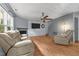 Bright living room with a fireplace, television, wood floors and two recliners offering comfortable seating and relaxation at 119 Tadworth Ct, Mebane, NC 27302