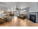 Open-concept living room featuring hardwood floors, fireplace, ceiling fan and view into the kitchen and dining area at 119 Tadworth Ct, Mebane, NC 27302
