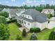Aerial view highlighting the home's lush backyard, patio and screened in porch at 121 Hardy Oaks Way, Holly Springs, NC 27540