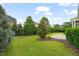 Lush backyard with mature trees and landscaping creates a serene and private outdoor space at 121 Hardy Oaks Way, Holly Springs, NC 27540