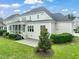 Backyard showcasing the patio, lush lawn and mature landscaping offering a peaceful retreat at 121 Hardy Oaks Way, Holly Springs, NC 27540