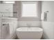 Serene bathroom features a modern soaking tub, glass-enclosed shower, and ample light at 121 Hardy Oaks Way, Holly Springs, NC 27540