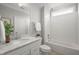 Bright bathroom features white cabinets, marble countertops, and subway tile shower at 121 Hardy Oaks Way, Holly Springs, NC 27540