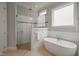 Bright bathroom showcases a glass-enclosed shower, soaking tub, and natural light at 121 Hardy Oaks Way, Holly Springs, NC 27540