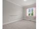 Cozy bedroom with neutral carpet, floral curtains, and chair rail at 121 Hardy Oaks Way, Holly Springs, NC 27540