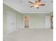 Large bedroom features ceiling fan, neutral carpet, and access to en suite bathroom at 121 Hardy Oaks Way, Holly Springs, NC 27540