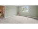 Cozy bedroom features neutral carpet, window, and an attached bathroom at 121 Hardy Oaks Way, Holly Springs, NC 27540