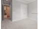 Neutral bedroom with carpet, an open doorway, and a closet at 121 Hardy Oaks Way, Holly Springs, NC 27540