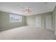 Large bedroom with neutral carpet, ceiling fan, and multiple closets at 121 Hardy Oaks Way, Holly Springs, NC 27540