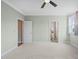 Neutral bedroom features plush carpet, ceiling fan, and an en suite bathroom at 121 Hardy Oaks Way, Holly Springs, NC 27540