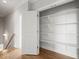 Open closet featuring wooden floors and shelving and hanging space at 121 Hardy Oaks Way, Holly Springs, NC 27540