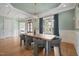 Formal dining room has hardwood floors, elegant lighting, and decorative trim throughout the space at 121 Hardy Oaks Way, Holly Springs, NC 27540
