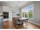 Bright dining area featuring a wood table, chandelier, large window, and built-in ovens at 121 Hardy Oaks Way, Holly Springs, NC 27540
